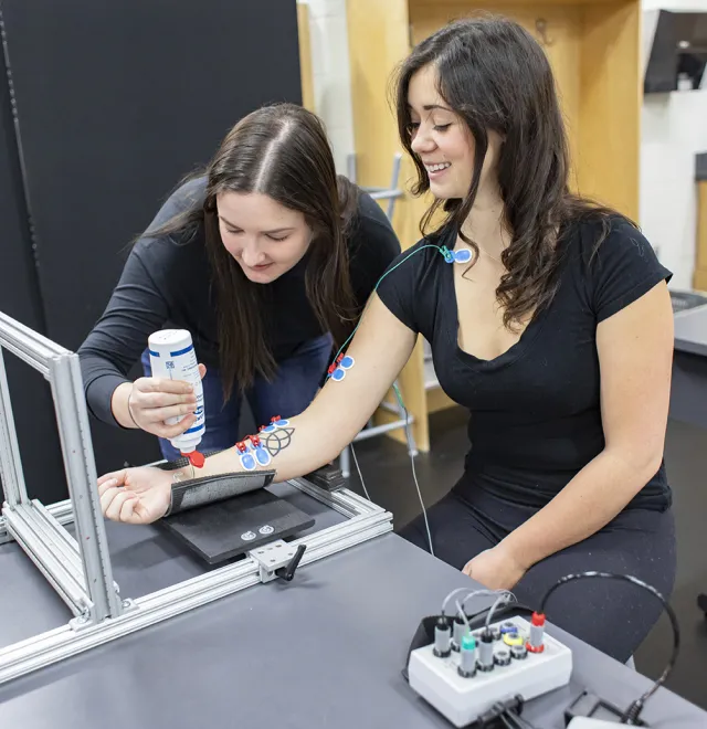 Two students taking measurements