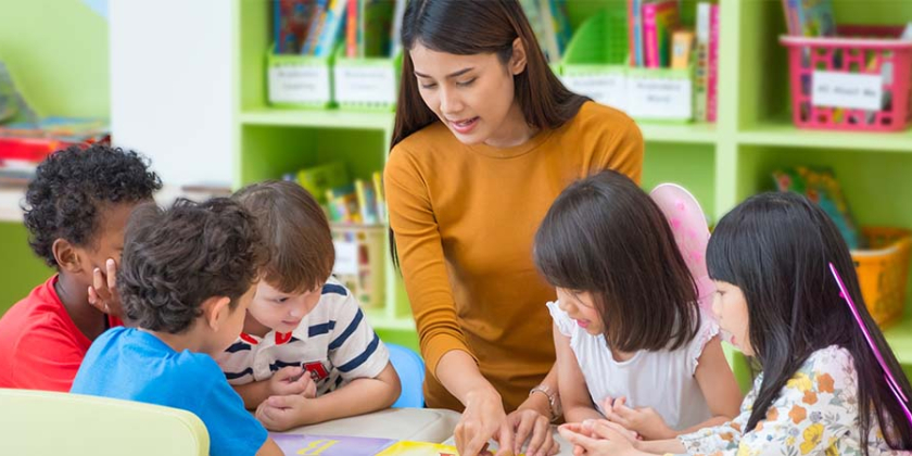 A teacher working with students in a classroom