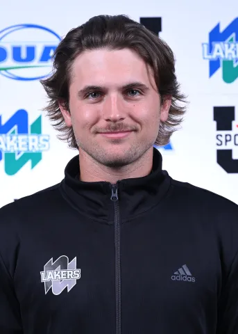 Jonathan Reese smiling into the camera with a Lakers backdrop