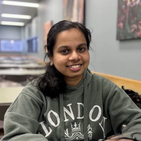 A student in dull green hoodie