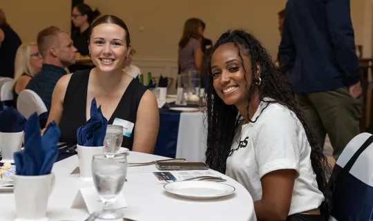Nakissa Koomalsingh at table with guest