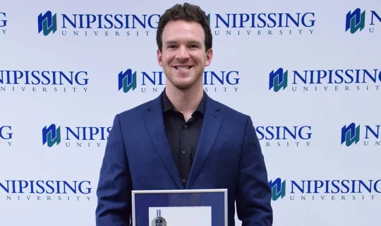 Nicholas Hoey with award