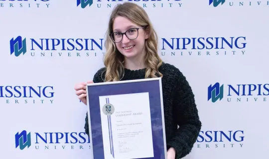 Sarah Pecoskie-Schweir with award