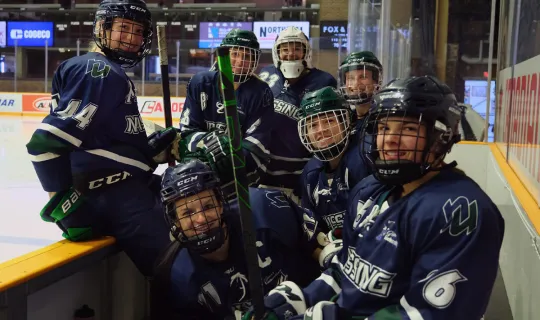 Women's Hockey team on bench