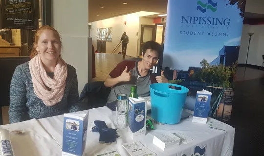 NUSA volunteers at a table in the Education Centre lobby