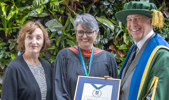 Catherine Gregory and Chancellor Russell stand with Maria Cristina Aguilera Valle, recipient of this year's Chancellor's Medal for Humanity
