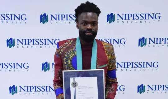 Elisa Butoyi with DMLA award
