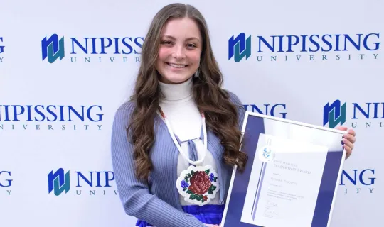 Hannah Turcotte with DMLA award