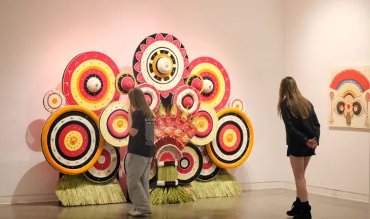 Lakers examining a big art installation during NU Homecoming 2025