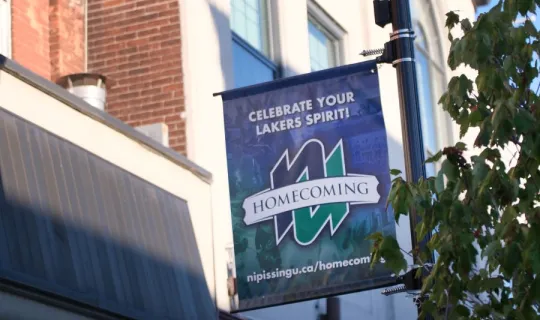 NU Homecoming 2025 flag, downtown North Bay, ON