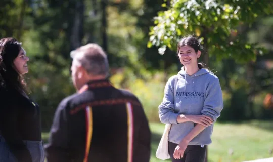 Lakers socializing outside during NU Homecoming 2025 Medicine Walk
