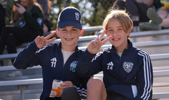 Two young boys posing for a photo during NU Homecoming 2025