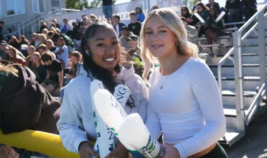 Two Lakers with thunder sticks during NU Homecoming 2025