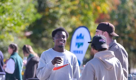 Lakers socializing outdoors during NU Homecoming 2025