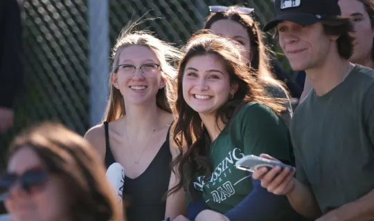 Lakers smiling on stands during NU Homecoming 2025
