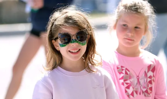 Two young girls outside during NU Homecoming 2025