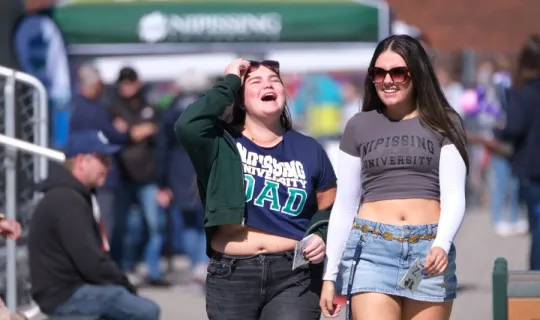 Two Lakers enjoying a walk together during NU Homecoming 2025