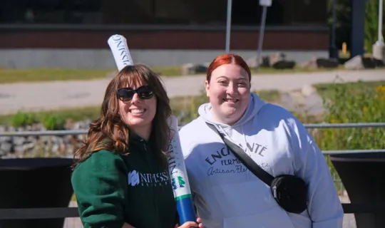 Two Lakers posing for a photo during NU Homecoming 2025