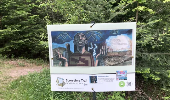 StoryWalk sign on the campus trail