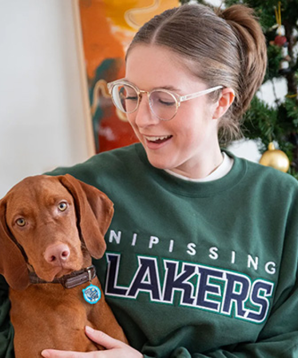 female with Lakers Sweatshirt and dog with Lakers tag