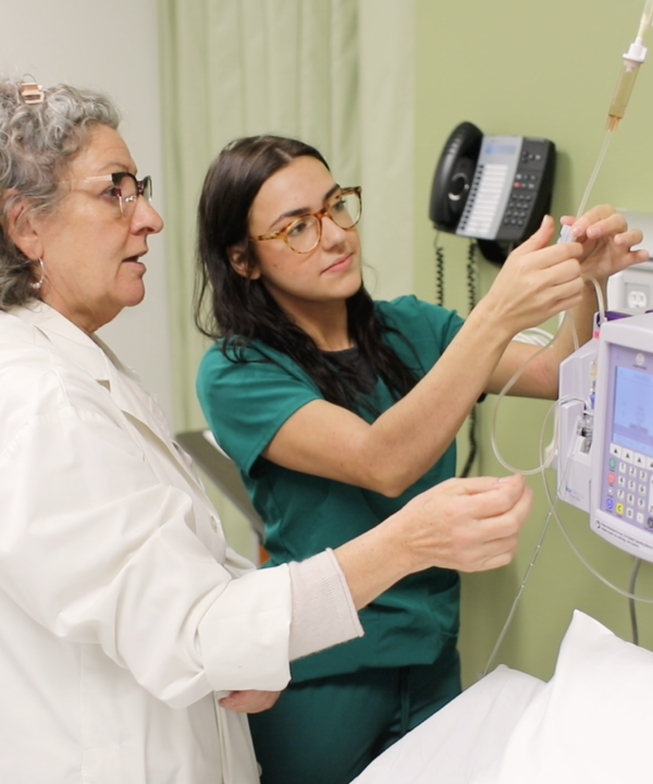 A nursing professor and student working in the simulation lab