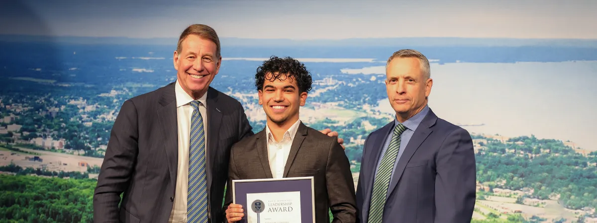 photo of Dr. Scott Russell, Chancellor of Nipissing University, Alexander Domingos, DMLA Recipient in the Campus category, and Dr. Kevin Wamsley, President and Vice-Chancellor of Nipissing University