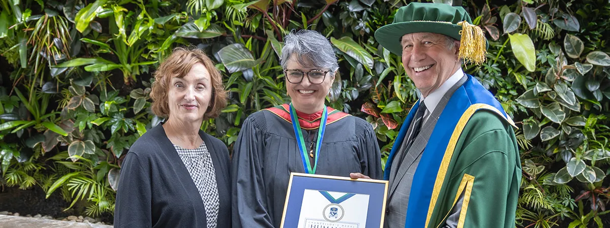 Catherine Gregory and Chancellor Russell stand with Maria Cristina Aguilera Valle, recipient of this year's Chancellor's Medal for Humanity