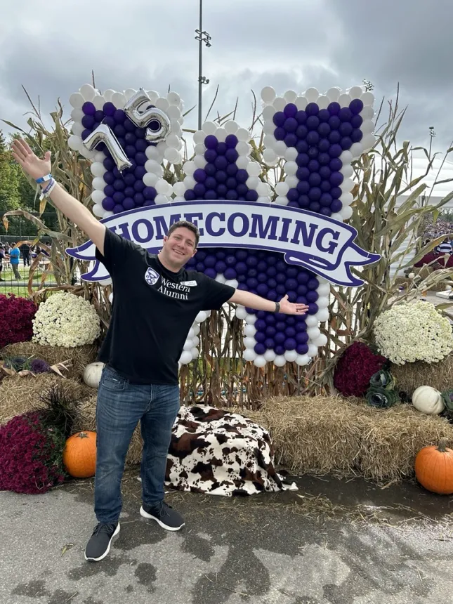 Steve in from of the Fall Homecoming display at Western University 