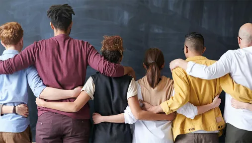 back facing group shot of everyone with their arm's around each other