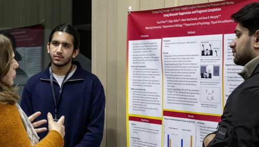 Students and community members networking and showcases research posters