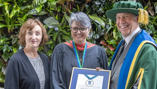 Catherine Gregory and Chancellor Russell stand with Maria Cristina Aguilera Valle, recipient of this year's Chancellor's Medal for Humanity