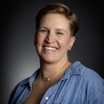 Headshot of Claire Nicholls on black background