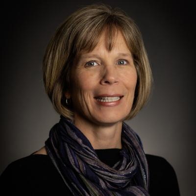 Woman in scarf smiling at camera