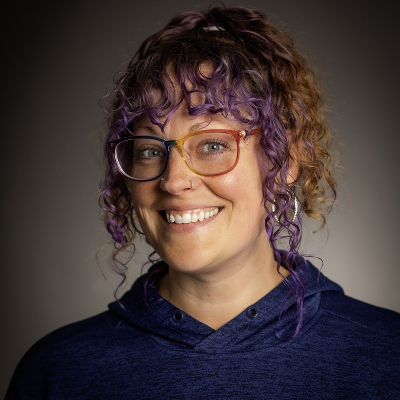 Woman in Nipissing University hoodie smiling.